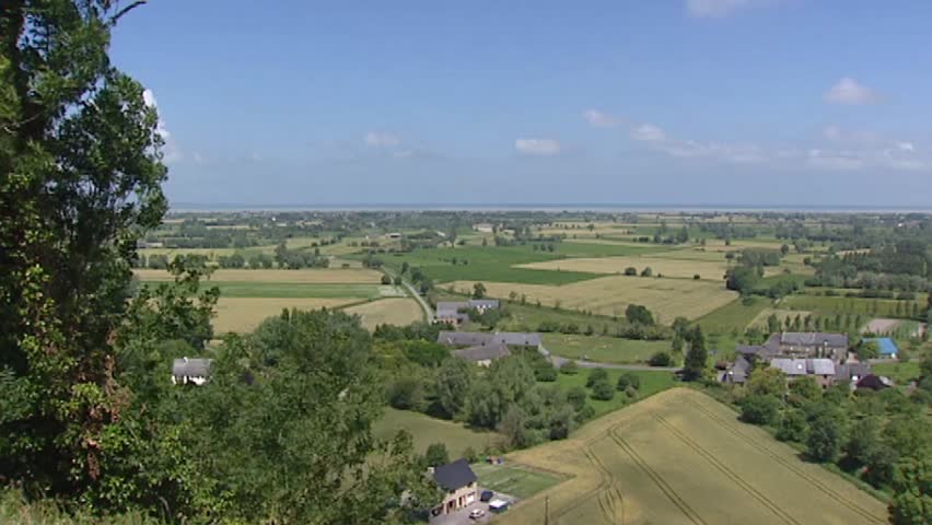 View over French landscape from Mont Dol, coast English Channel in background.