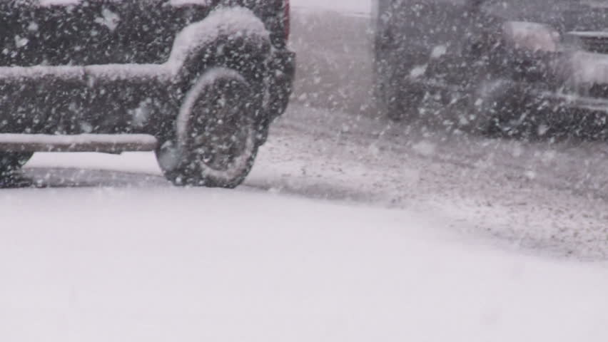 Cars on slippery road in blizzard. 