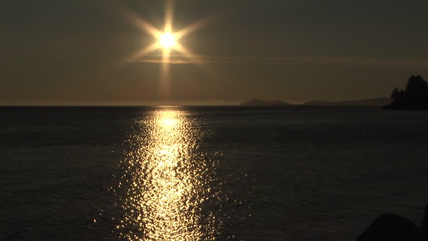Starlight sun with golden reflection on sea at sundown
