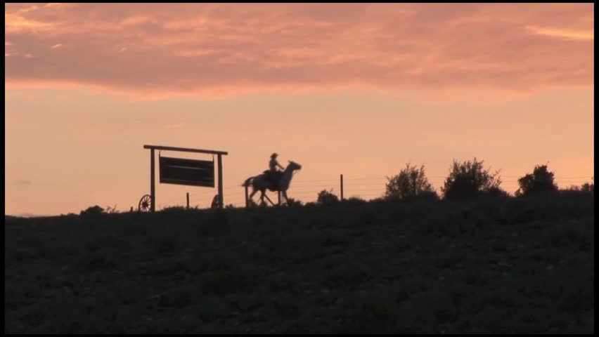 COWGIRL RIDING RIDGE AT SUNRISE BEAUTIFUL SILHOUETTE