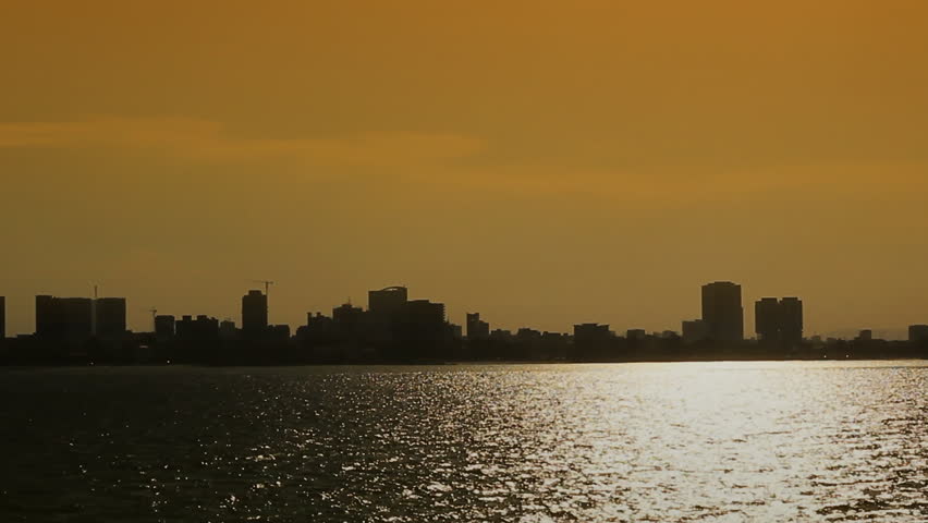 view of dar es salaam from the sea,moving shot taken from a boat at dusk