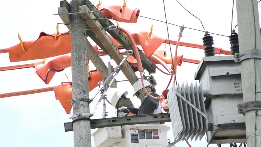 Electricians repairing power transformer.