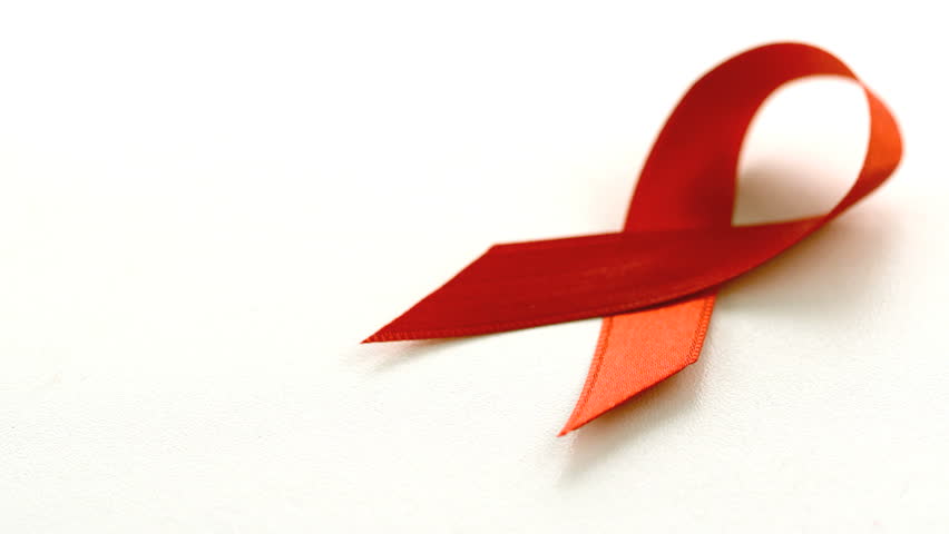 Red ribbon falling over on white background in slow motion