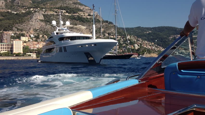 Cruising past luxury super yachts at anchor off Monaco