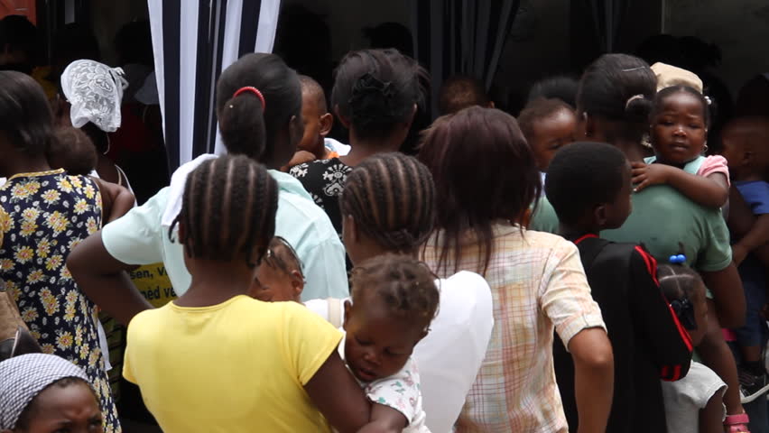 HAITI - CIRCA MAY 2012: lines of people at vaccination clinic in Port-Au-Prince Haiti