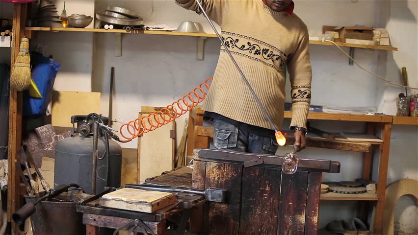 Glass Fabrication In Murano, Italy - Video clip of artisan of glass creating a crystal vase - Murano, Venice, Italy.