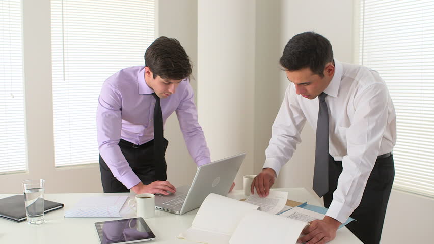 two businessmen working hard in the office