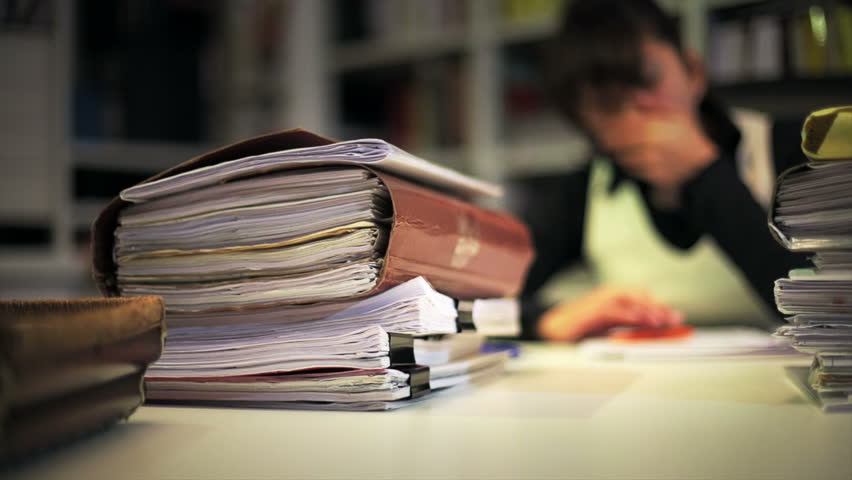 Female student falls asleep after been reading and studying all day in the library