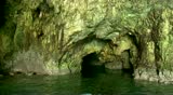 POV from a small boat going through cave in Raweche Rocks