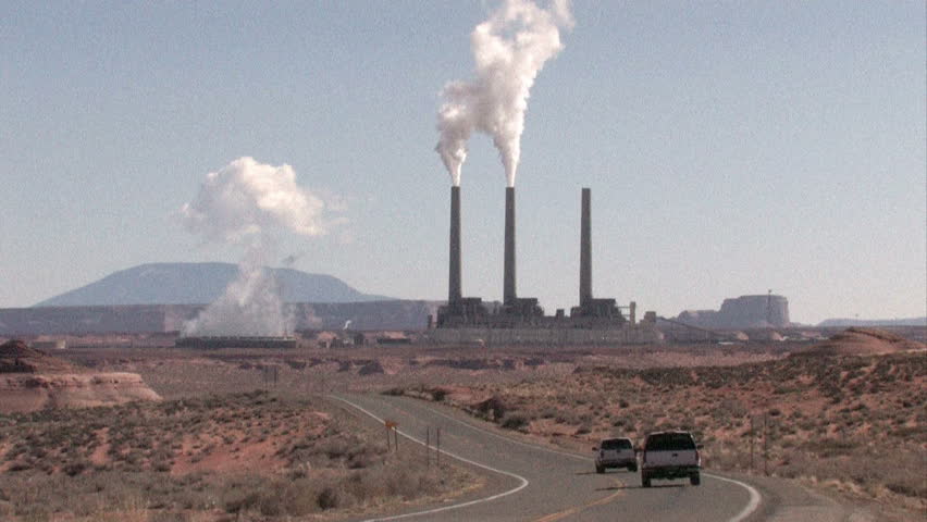 Traffic, pollution, smoke and steam coal powered electrical plant. Navajo Generating Station Page Arizona.  Contamination, pollution and global warming with associated climate change. Trucks.