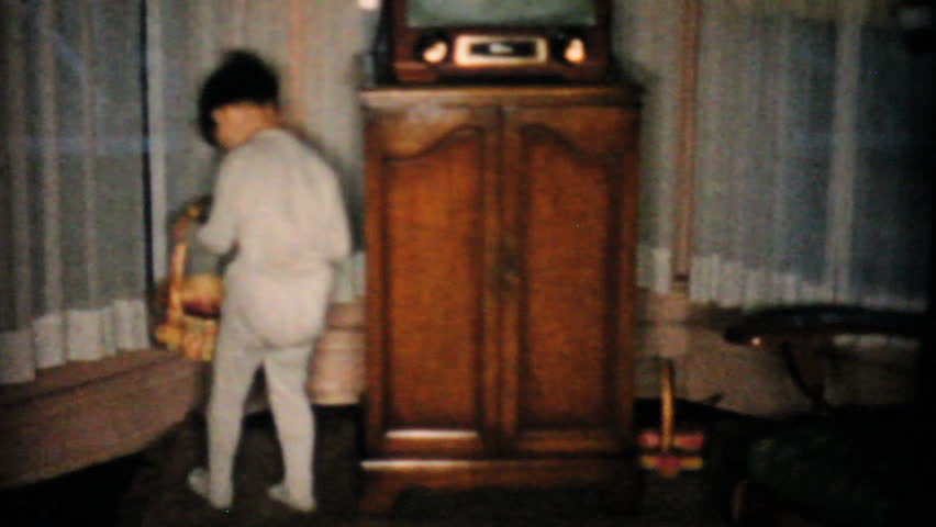 JOHNSTOWN, NEW YORK, 1957: A cute little boy finds lots of yummy Easter eggs on his Easter egg hunt in 1957.