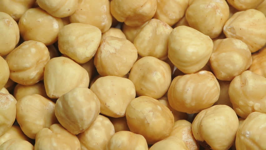 A pile of shelled hazelnuts rotating slowly