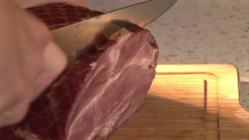 Cutting Ham (meat) on sandwiches
