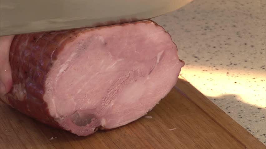 Cutting Ham (meat) on sandwiches