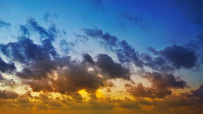 1920x1080 video - Time lapse clip of red, blue and yellow fluffy clouds over blue sky on sunset