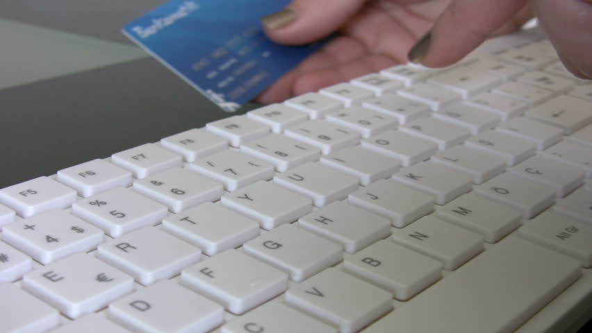Woman confirming credit card data for e-commerce.