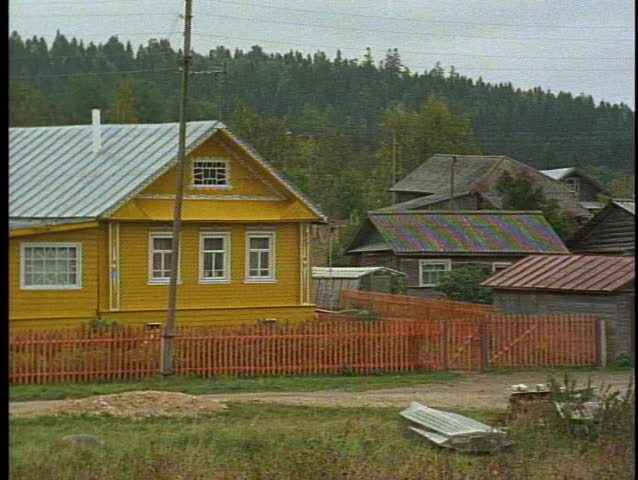 Russia, Peasant Village, houses, yellow, pan left medium shot