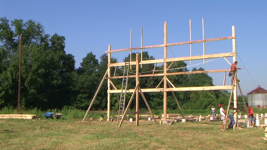 Time lapse of carpenters building barn. 