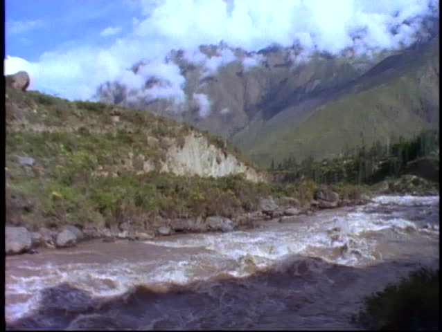 Peru, The Andes, train ride through Andes on narrow gauge, POV passing raging river
