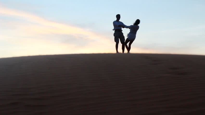 Beautiful couple dancing in desert