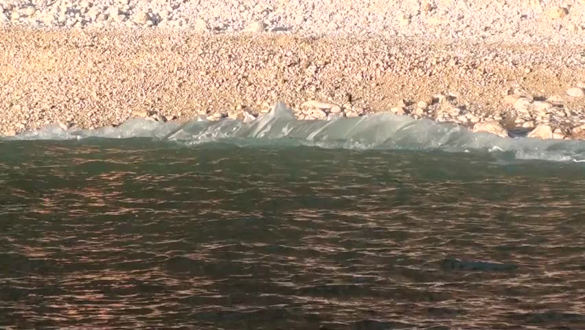 Beach view from the sea â waves washing pebbles, with audio