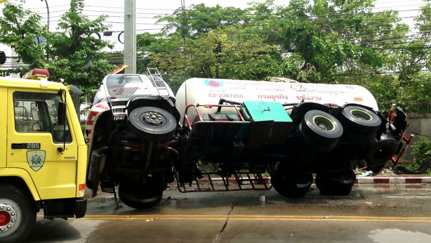 BANGKOK - APRIL 15: A rolled-over gas truck is being craned back on wheel in Bangkok, Thailand, on April 15, 2013. The gas truck crashed after a brake failure