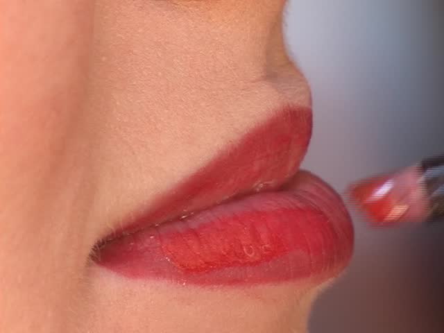 Make-up artist applying cosmetics to woman