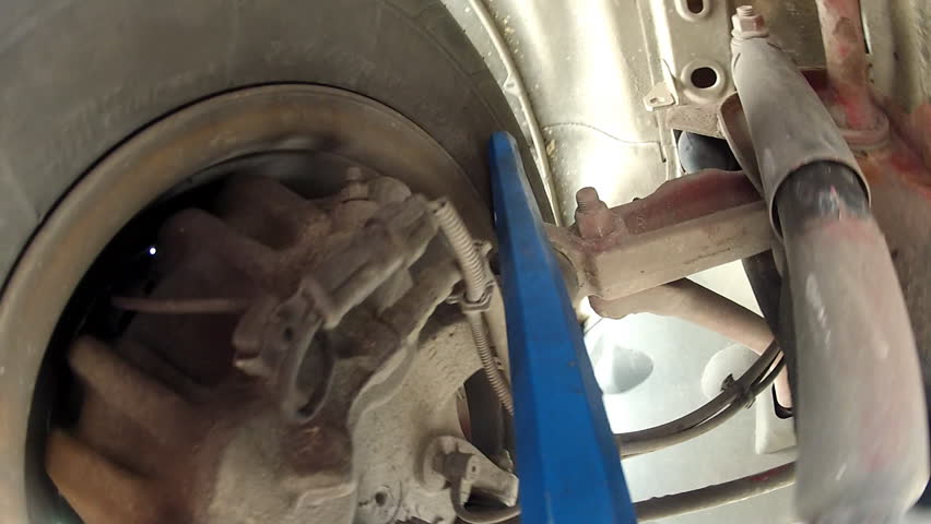 Under the truck -  Mechanic checking the truck.                             