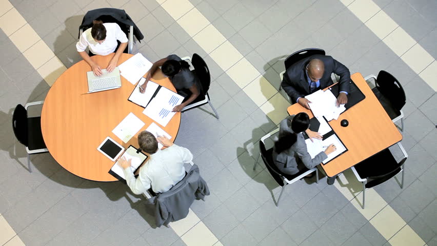 Satisfaction of success by group of multi ethnic business people and clients around table
