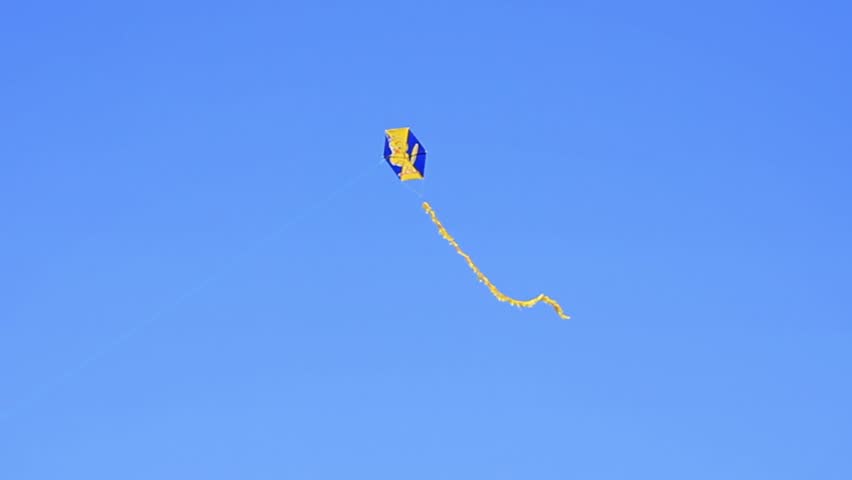 Flying kite against clear blue sky
