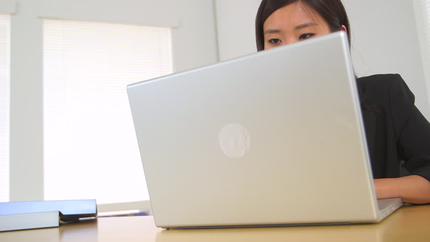 Successful Chinese businesswoman at desk
