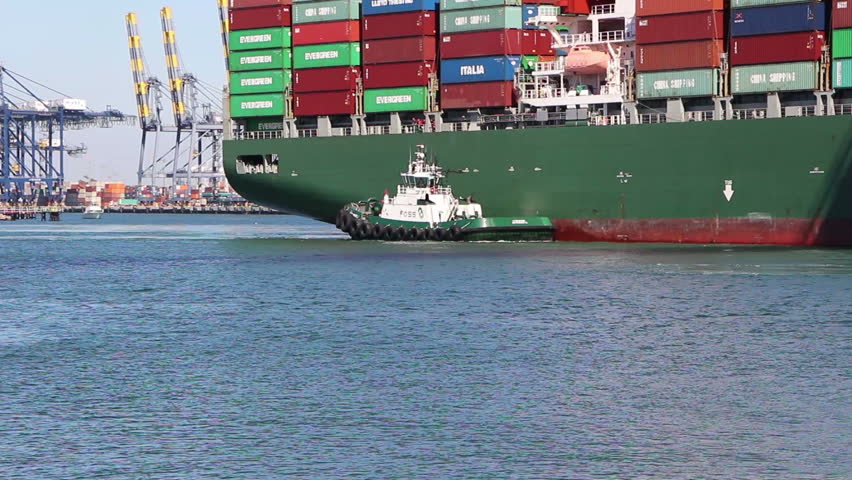 LOS ANGELES - NOV 2: Tugboat assists a Container Ship mooring at dock in Los Angeles on November 2, 2012