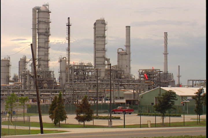 CONVENT, LOUISIANA - CIRCA SEPTEMBER 1999: Pan across many smokestacks of Convent oil refinery.