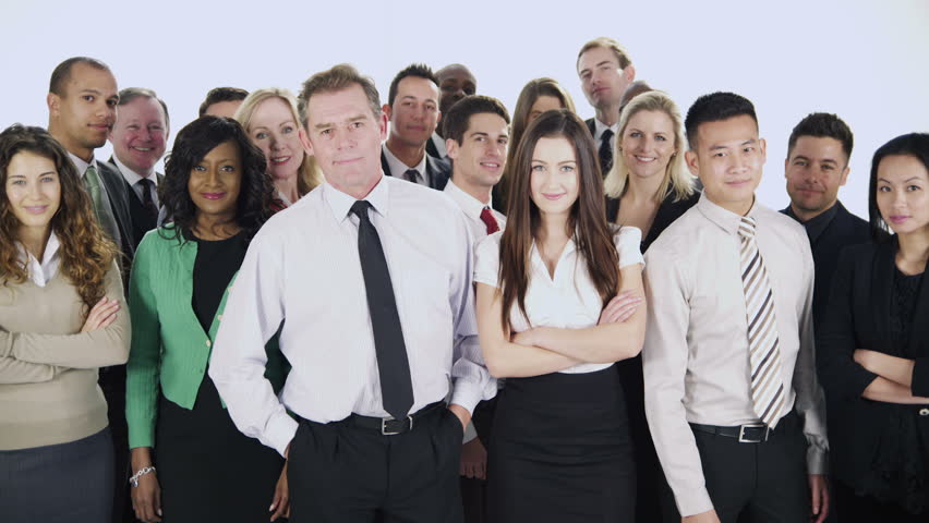 Portrait of a large group of happy and diverse business people standing together, isolated on white in a studio shot. They are talking amongst themselves then they look to the camera and smile. 