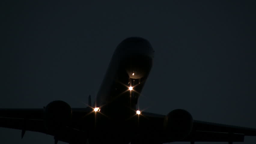 Airplane flying overhead at night
