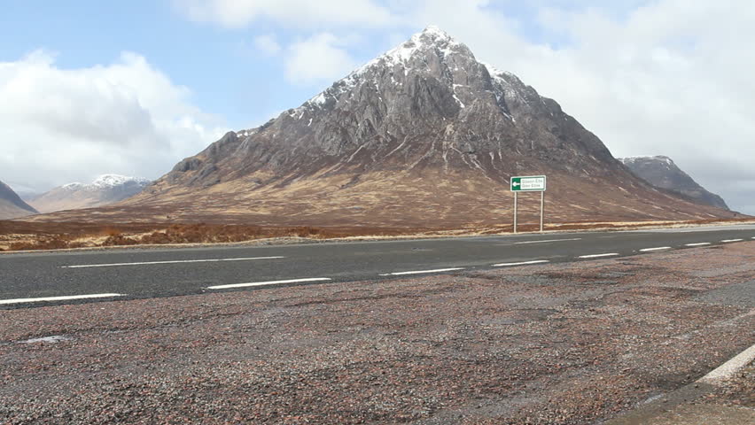 Car driving towards Glen Coe Scotland
