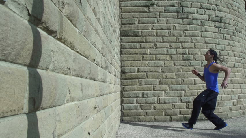 Backflip - A free runner back flips off a wall in super slow motion