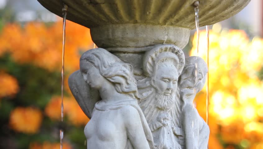 Water Fountain with Renaissance Figures Theme on a Bright Yellow Orange Azalea Flowers Out of Focus Bokeh Background 1920x1080