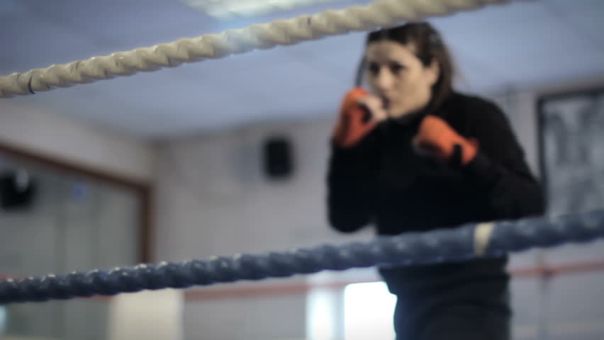 Boxing Ring - a female boxer entering ring and shadow boxing
