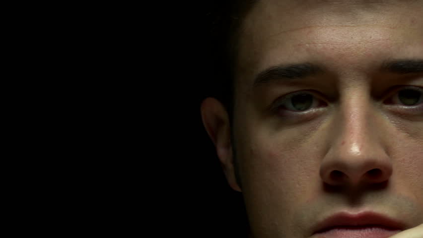 Dolly shot of man in color. Experimental lighting. 