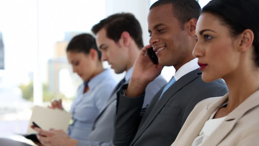 Business people sitting and waiting in a waiting room