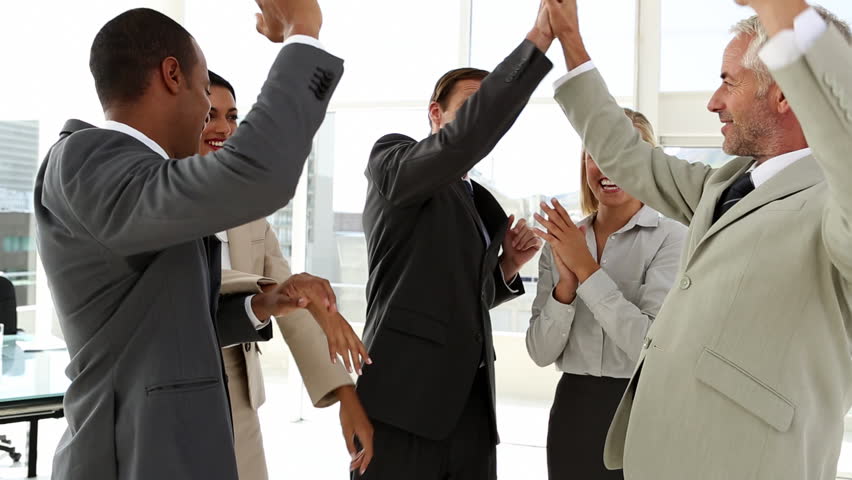 Business team bonding together in office with large window