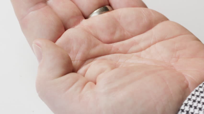 Man taking aspirin tablet into hand