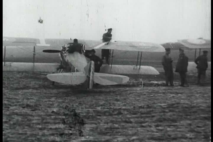 1910s - Eddie Rickenbacker and the 94th Aero Squadron roll out their fighting planes in World War One.
