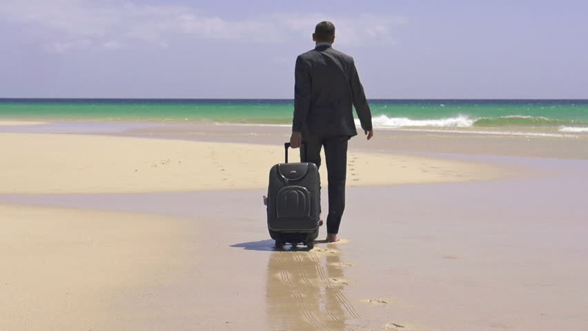 Businessman with suitcase walking on exotic beach, super slow motion, shot at 240fps
