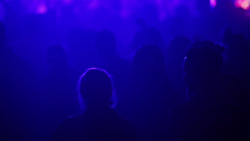 Couple talking together during a music performance

