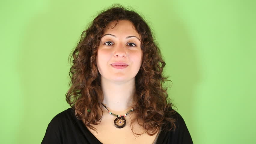 Young Woman Gesturing on Green Background