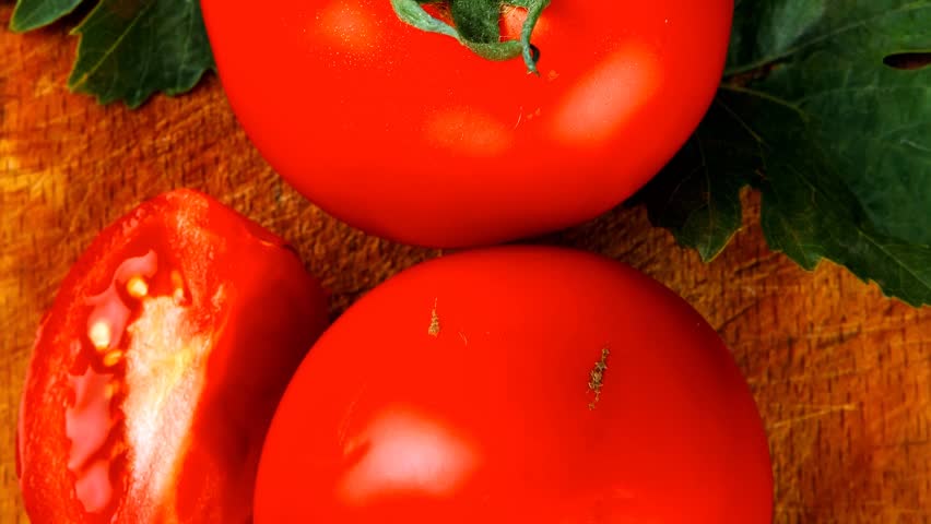 raw vegetables : some uncooked ripe fresh tomatoes over blue table on cutting board 1920x1080 intro motion slow hidef hd