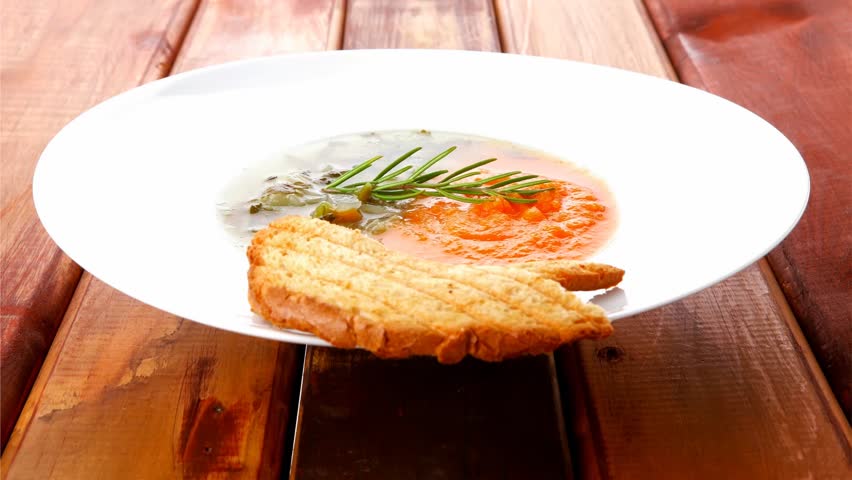 european cuisine: dual components vegetable soup served with toasts on wood 1920x1080 intro motion slow hidef hd