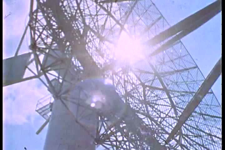 1960s - A satellite dish monitors space communication.